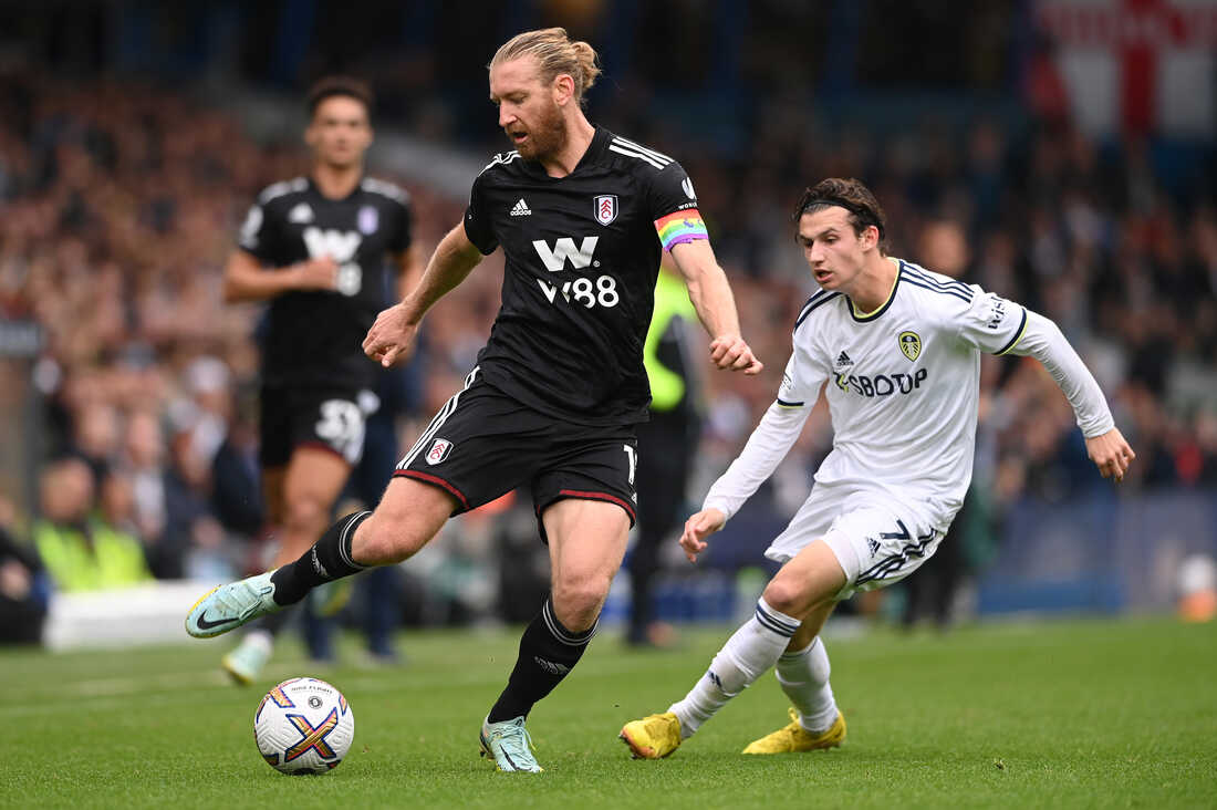 LEEDS, ENGLAND - OCTOBER 23: Leeds United player Brenden Aaronson (r) chases down Fulham captain Tim Ream, wearing the Rainbow captain's arm band during the Premier League match between Leeds United and Fulham FC at Elland Road on October 23, 2022 in Leeds, England. (Photo by Stu Forster/Getty Images)